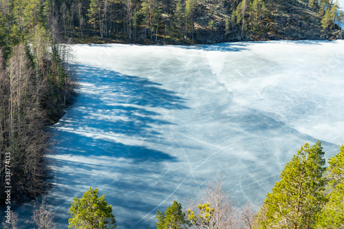 Beautiful landscape with icy lake in the national park Repovesi, Finland photo