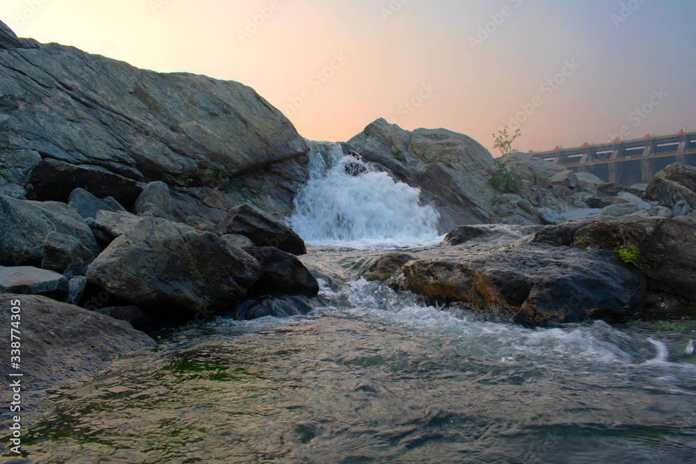 closeup image of water flowing between the rocks