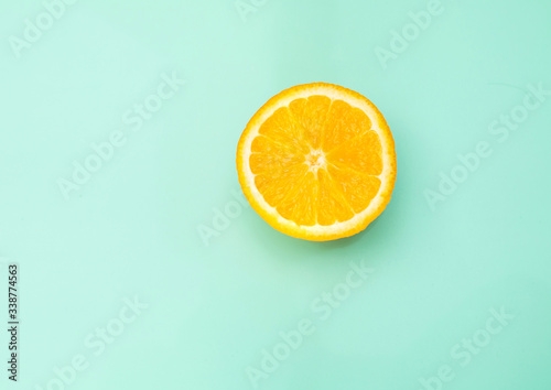sliced orange on a bright green background