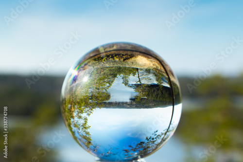 Beautiful landscape in glass ball with icy lake in the national park Repovesi  Finland