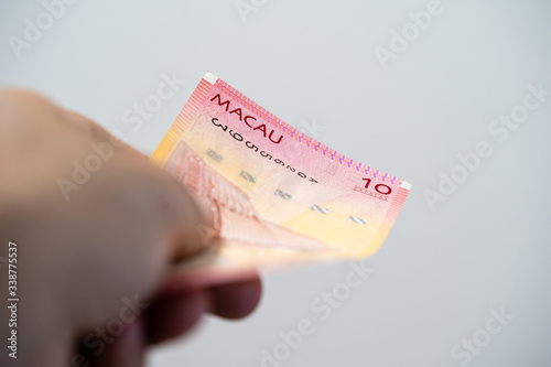 Paying with ten patacas bill, from Macao photo