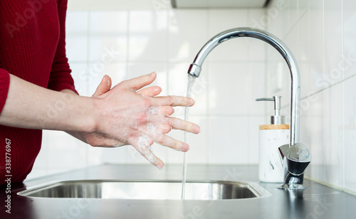 Washing hands in kitchen