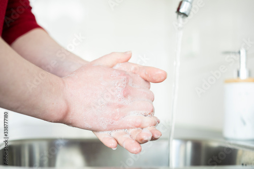 Woman washing hands in kitchen