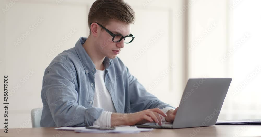 Young student typing on laptop, studying at home Young student typing on laptop, studying at home
