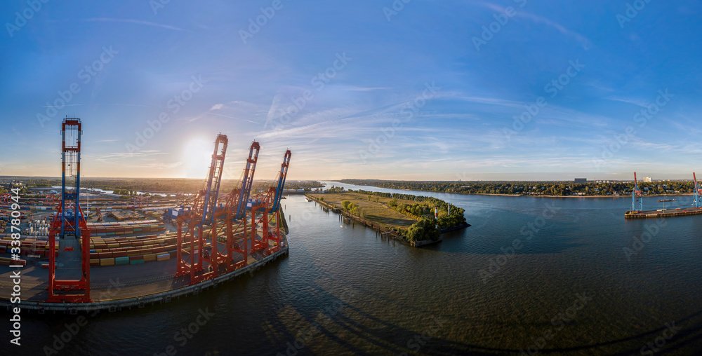 Aerial view of a container terminal in the port of Hamburg at sunset 