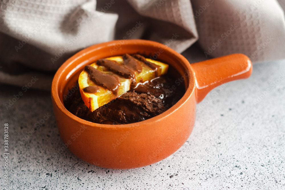 Delicious chocolate pudding with orange. Potted pudding on the table Delicious chocolate pudding with orange. Potted pudding on the table