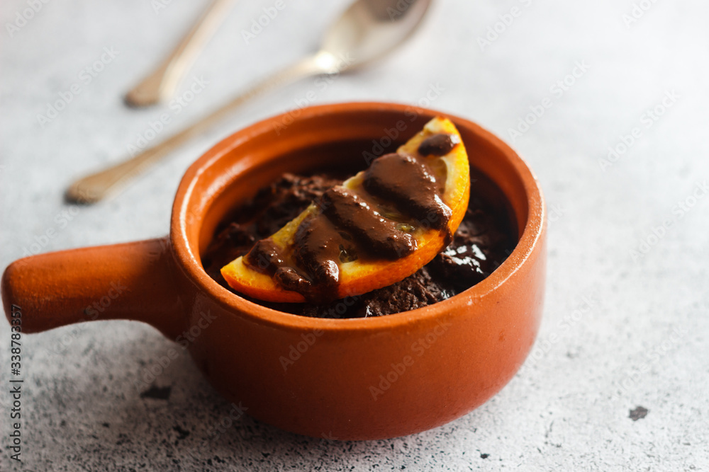 Delicious chocolate pudding with orange. Potted pudding on the table Delicious chocolate pudding with orange. Potted pudding on the table