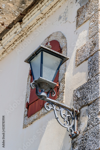 MOSTAR, BOSNIA HERZEGOVINA - 2017 AUGUST 16. Street lamp and a window with iron shutters in the Old Bazaar Kujundziluk, the muslim quarter of the old town of Mostar. photo