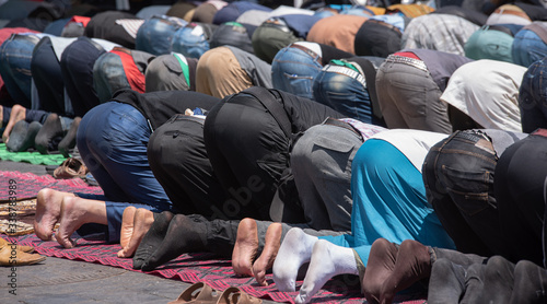 Moroccans praying in ramadan on carpet, posture mujut, Salat photo