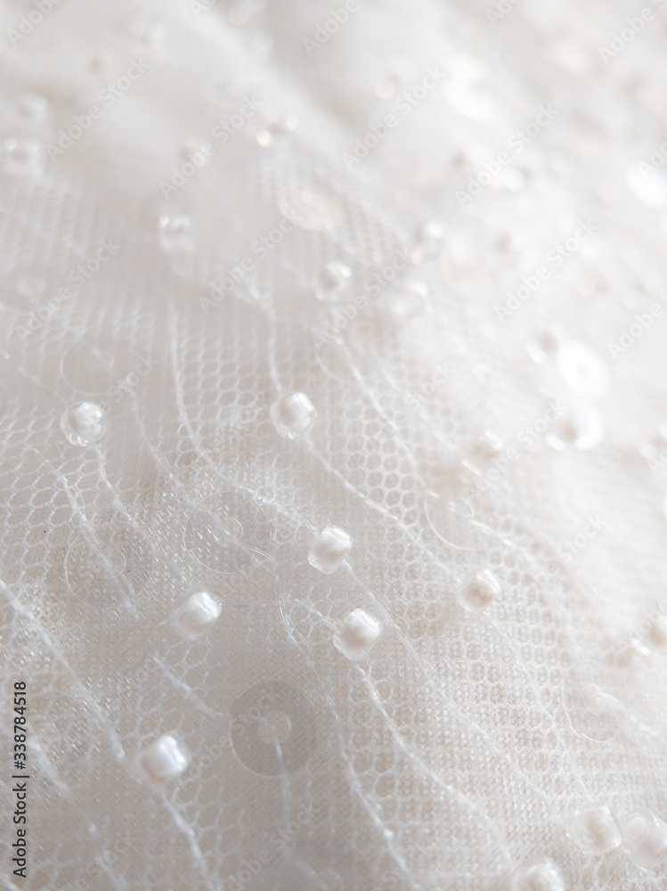 close up on shiny bridal white round sequin fabric texture detail close up on shiny bridal white round sequin fabric texture detail