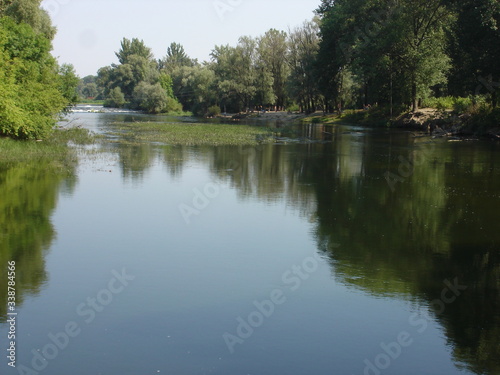 A wide, calm river on a summer morning.