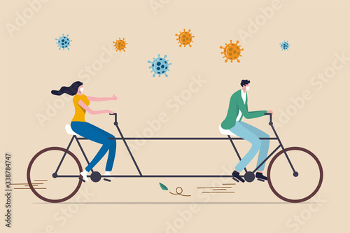 Social distancing, people keep distance in public to protect from COVID-19 Coronavirus outbreak spreading concept, couple man and woman keep distance away on tandem bicycle with Coronavirus pathogens.
