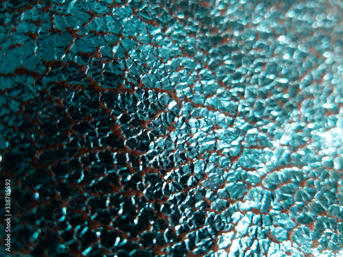 foiled aqua blue fabric background with shinny reflective cracked surface
