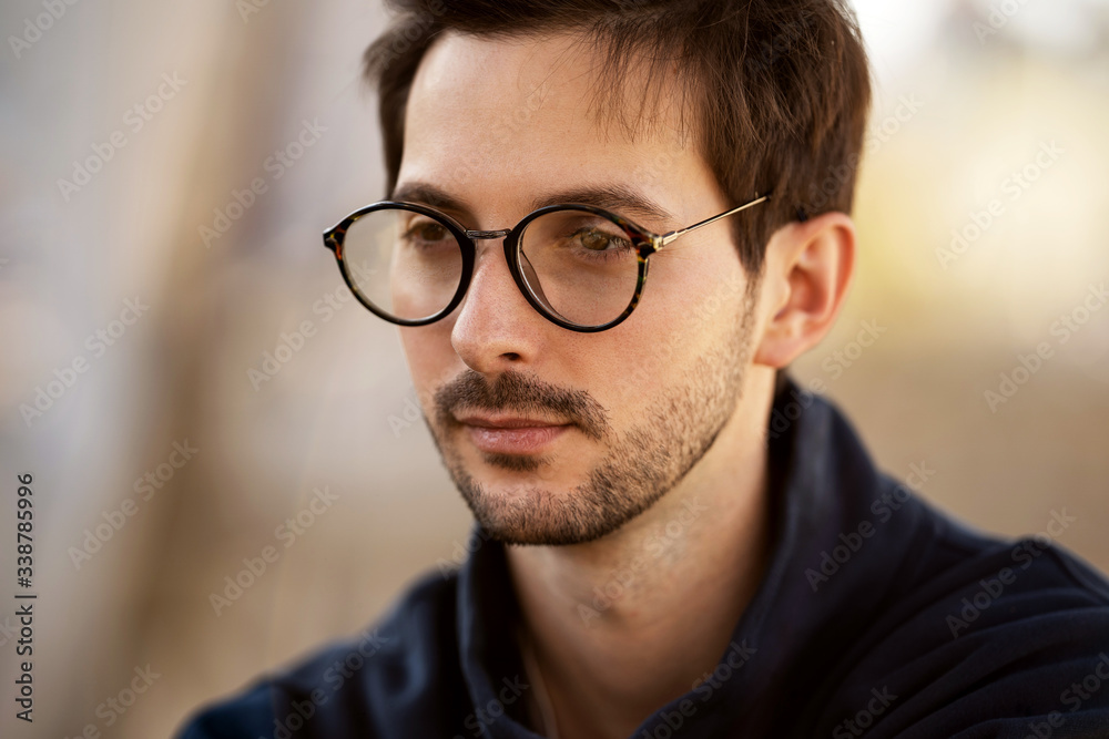 portrait of a guy with glasses posing outdoors portrait of a guy with glasses posing outdoors