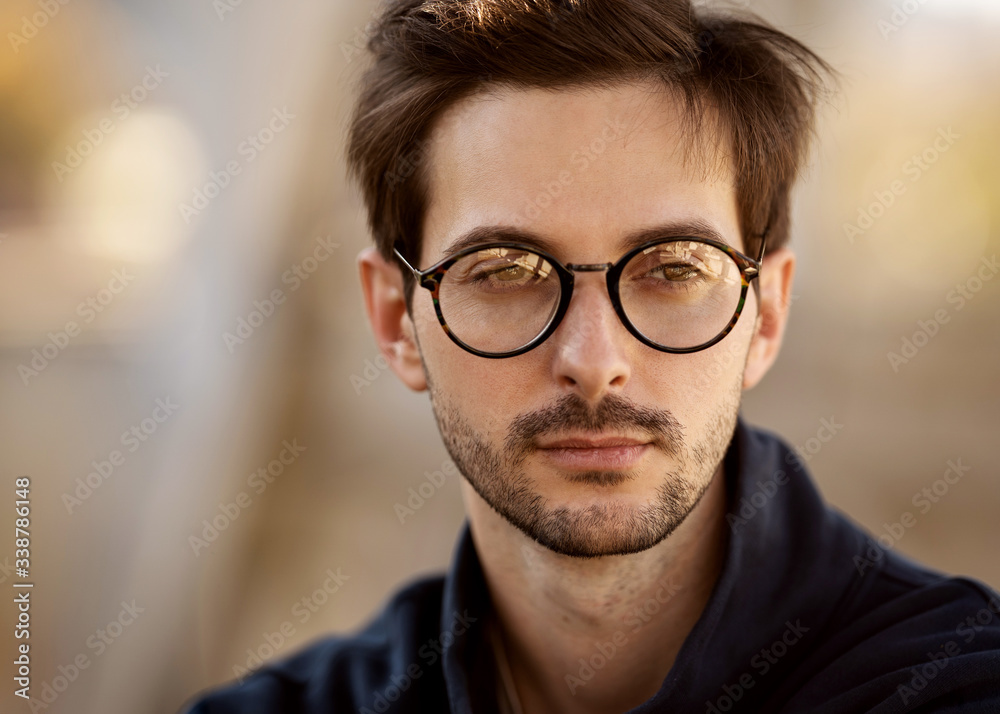 portrait of a guy with glasses posing outdoors portrait of a guy with glasses posing outdoors