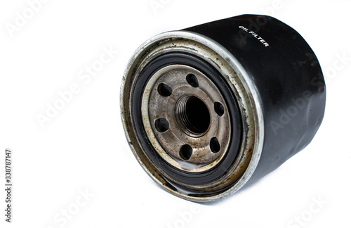 Old and dirty oil filter isolated on white background.Copy space