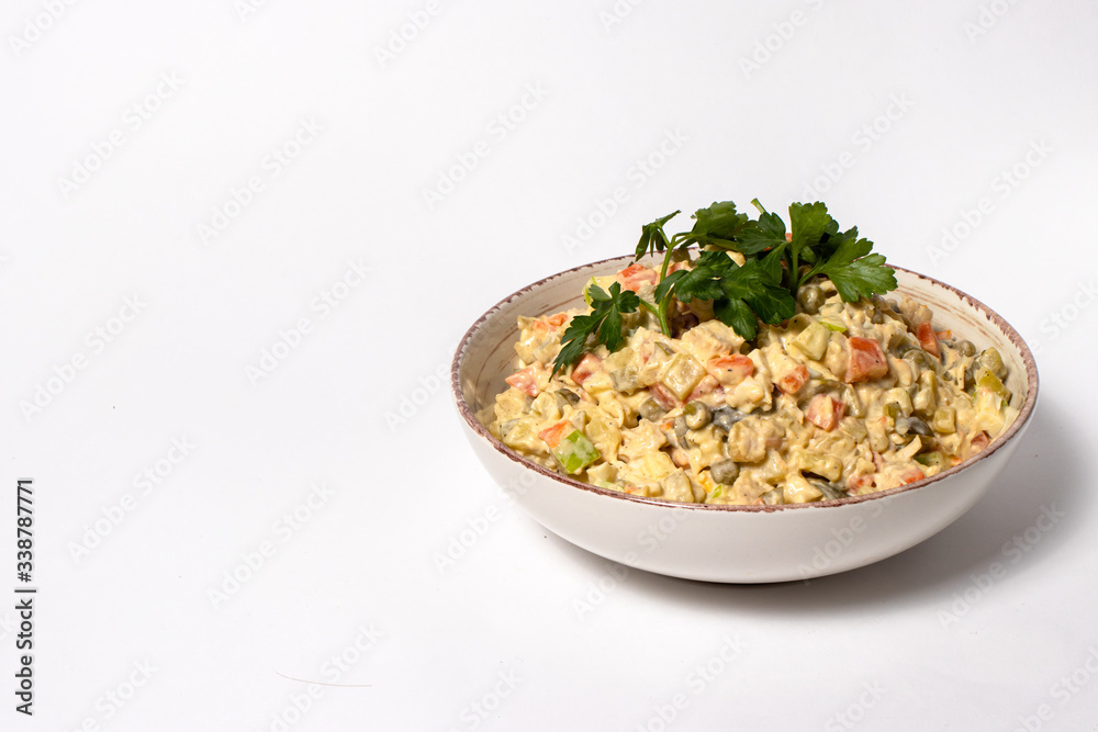 Olivier salad - a classic recipe with mayonnaise, an incredible taste. Olivier salad on a white background, homemade recipe. Olivier salad - a classic recipe with mayonnaise, an incredible taste. Olivier salad on a white background, homemade recipe.