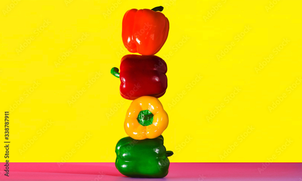 Paprika tower on Yellow background Peppers. Food concept.