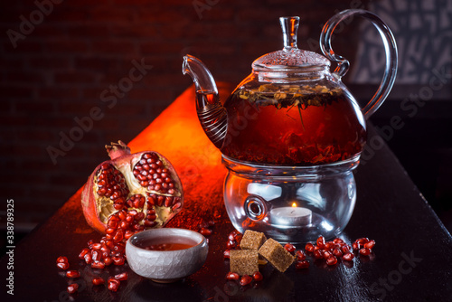 Natural tea. Pour boiling water in a glass teapot, the ingredients are nearby