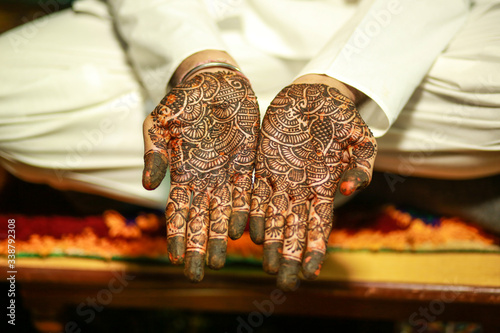 Indian traditional wedding ceremony mehandi on groom hand