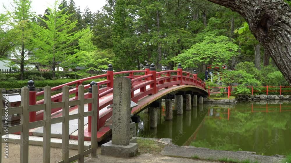 Red Bridge in the Hasu-ike park of - an old historical Lotus Pond, located in Koyasan - a small town in Japans prefecture Wakayama. Red Bridge in the Hasu-ike park of - an old historical Lotus Pond, located in Koyasan - a small town in Japans prefecture Wakayama.