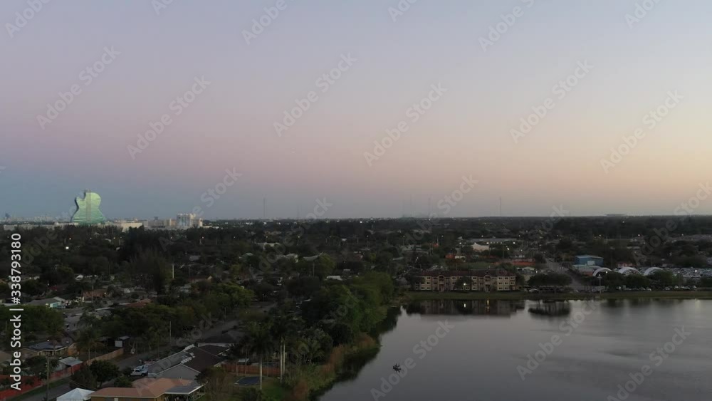 Aerial pan left of evening near Hollywood Florida over a lake and residential area, Hard Rock Resort Aerial pan left of evening near Hollywood Florida over a lake and residential area, Hard Rock Resort