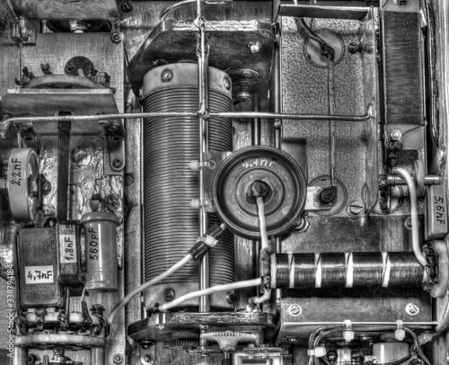 Inside view of high frequency power amplifier with capacitors, coils and other components in black and white