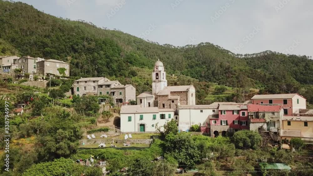 Drone shot above an old Italian catholic church surrounded by hills Drone shot above an old Italian catholic church surrounded by hills