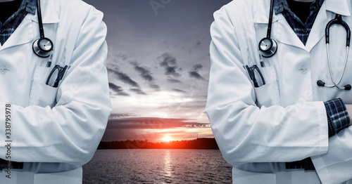 Obraz na płótnie Abstract sad dramatic picture with sunset over the lake and resuscitation doctors (death, loss, coronavirus - concept) w salonie