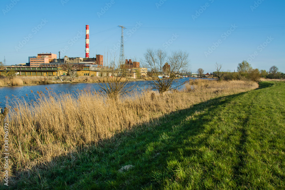 Beautiful spring landscape, river, reeds and power plant. Elblag in Poland