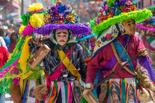 Costumized people dancing in a carnival show of Ocozocoautla de Espinosa, Chiapas, Mexico photo
