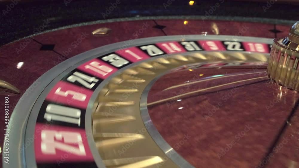 Close up of roulette wheel spinning roulette in a casino where the ball goes to the green or red or black number Close up of roulette wheel spinning roulette in a casino where the ball goes to the green or red or black number