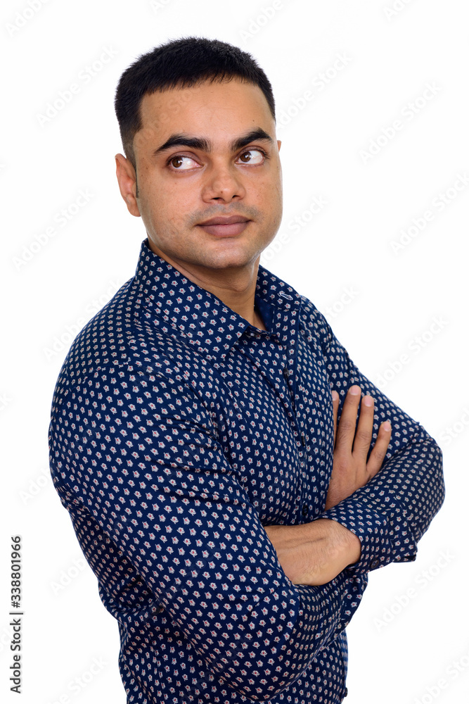 Studio shot of young handsome Indian man isolated against white background Studio shot of young handsome Indian man isolated against white background