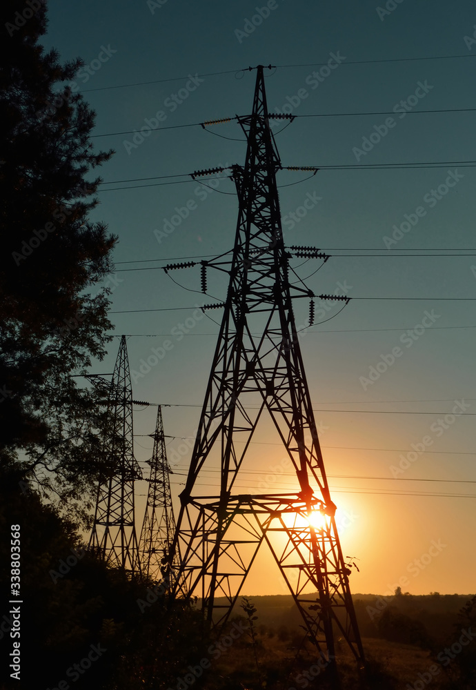 transmission lines tower in sunset