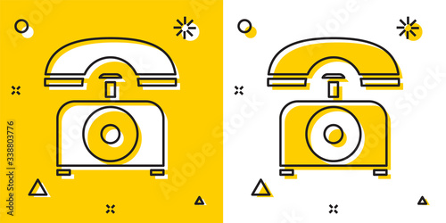 Black Telephone icon isolated on yellow and white background. Landline phone. Random dynamic shapes. Vector Illustration