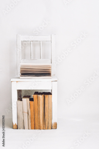 white chair in a room with books in the style of minimalism © инна меньшикова