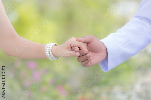 Love - romantic couple holding hands on a garden for the illustrations © kaewphoto