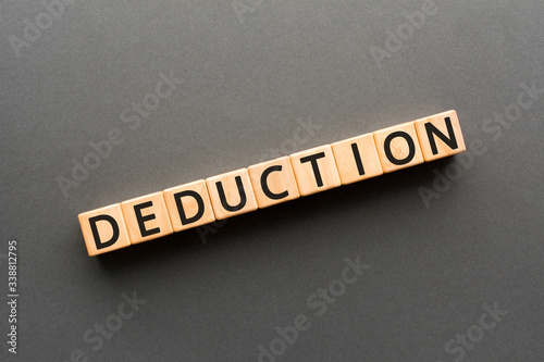 Photos Deduction - word from wooden blocks with letters, the process of reaching a deci