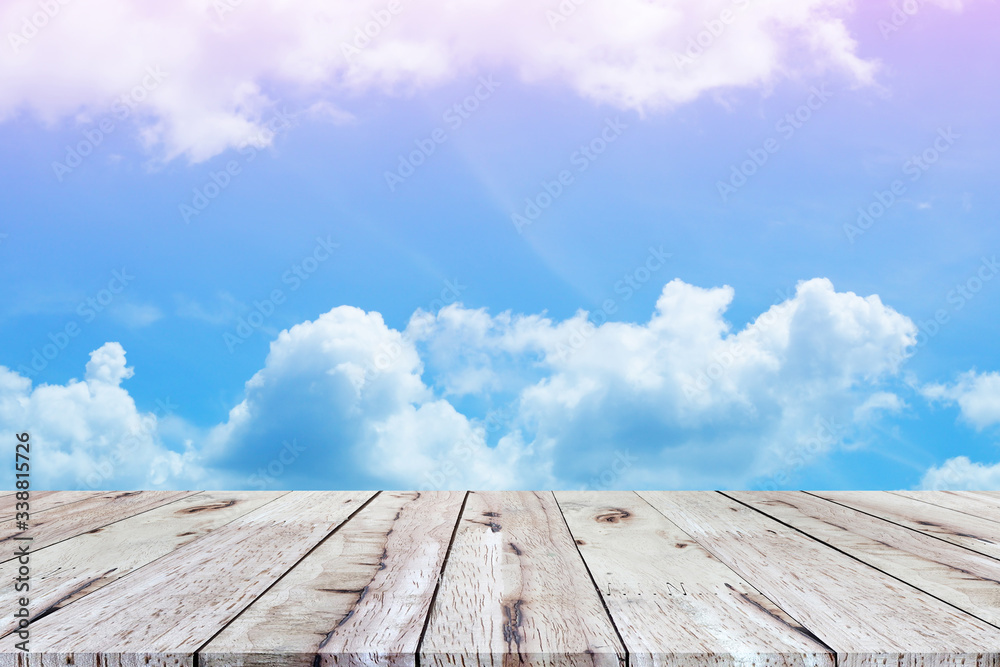 Beautiful empty wood plank table top with white cloud and blue sky background. for montage of your product Beautiful empty wood plank table top with white cloud and blue sky background. for montage of your product