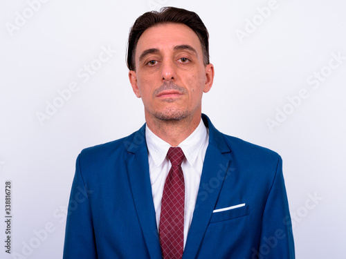 Mature handsome Italian businessman against white background