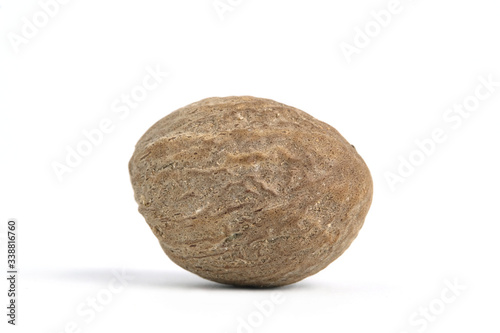 Closeup single nutmeg isolated on a white background