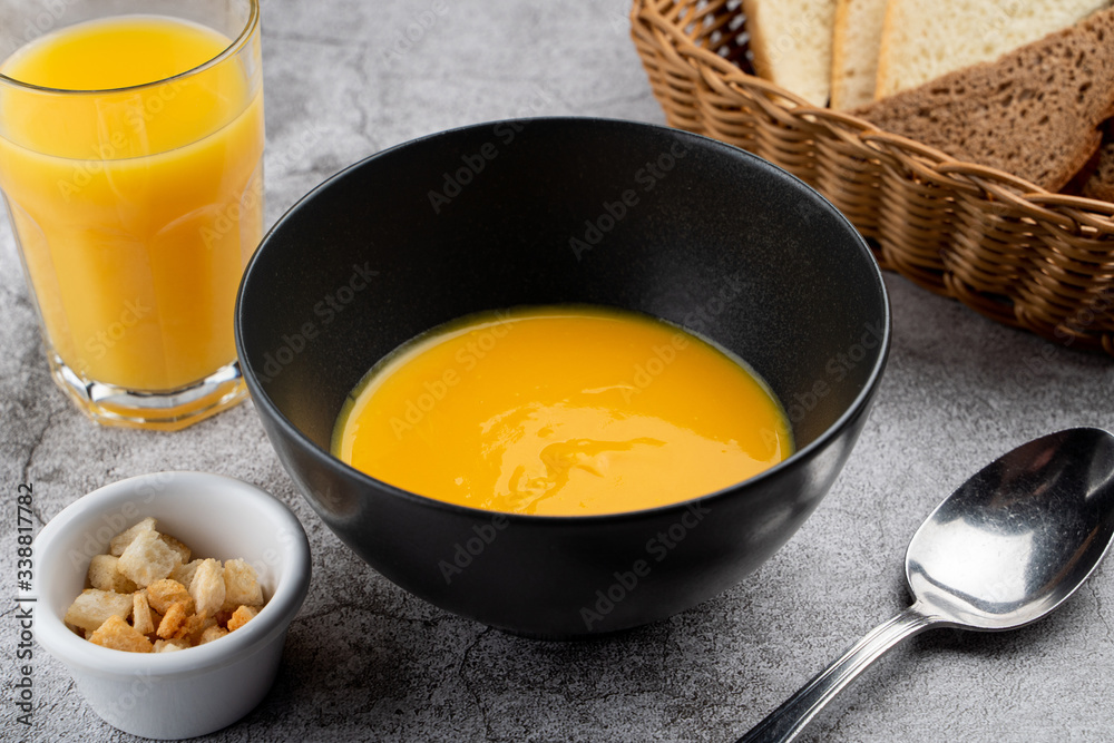 Pumpkin cream soup of pureed pumpkin and crunchy croutons close up Pumpkin cream soup of pureed pumpkin and crunchy croutons close up