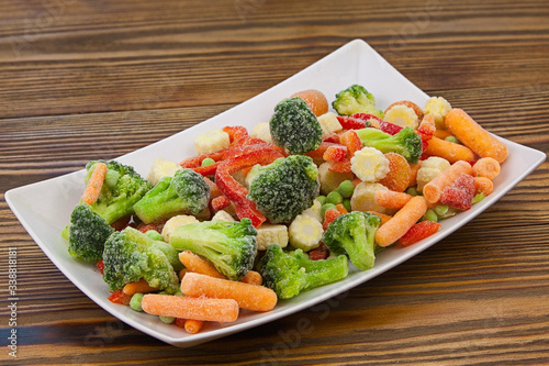 Frozen vegetables gorse or tomatoes corn peas bell peppers carrots on plate