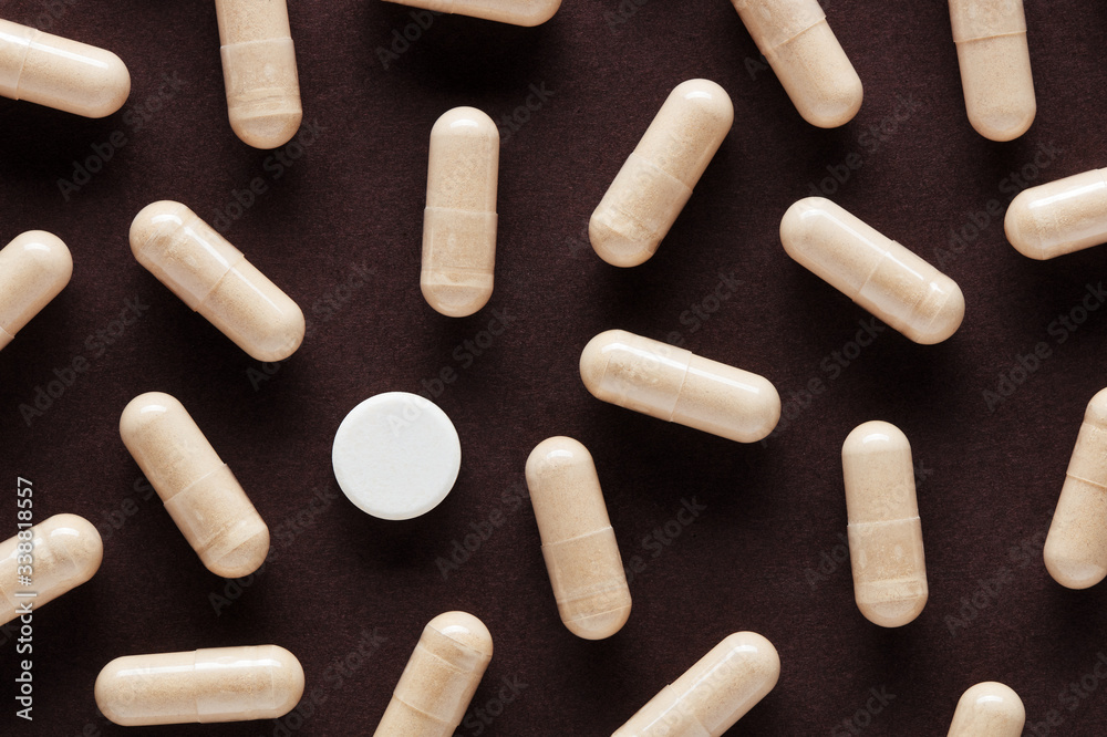 White medical pill stands out among many other capsule pills