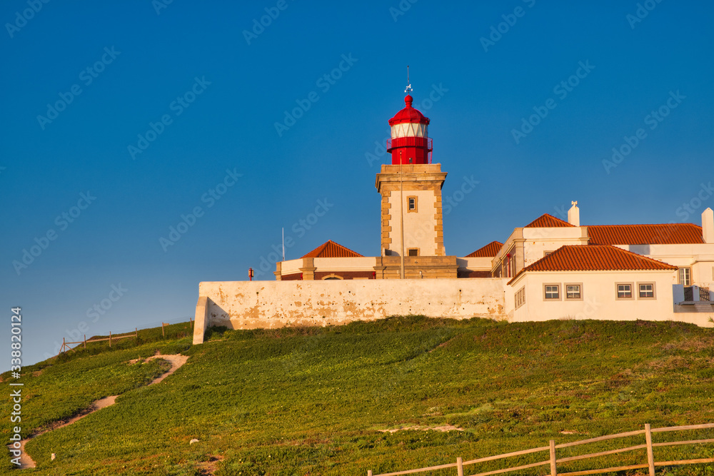 Cabo da Roca, Portugal - white lighthouse on cliffs at evening time. Cabo da Roca, Portugal - white lighthouse on cliffs at evening time.