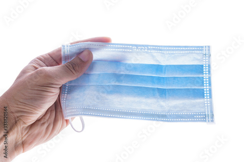 hand holding face mask isolated white background