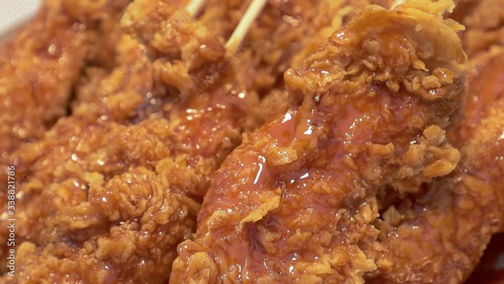 Asian street food - Crispy fried chicken with skewer at night market and walking street. Chiang mai., Thailand. Asian street food - Crispy fried chicken with skewer at night market and walking street. Chiang mai., Thailand.
