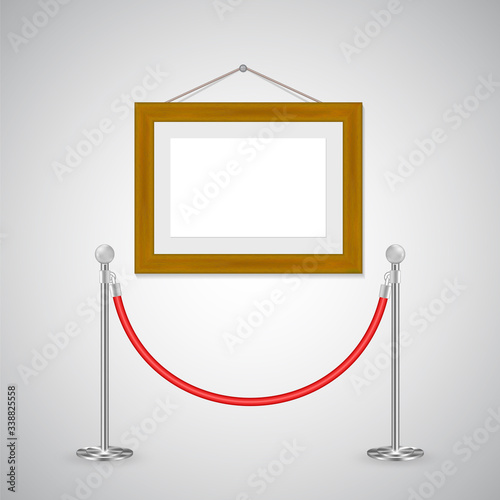 Restriction pole and red cord barrier and wooden frame hanging isolated on white background, interior decor with copy space for advertisement, artwork or poster template.  Gallery exhibition mock up.