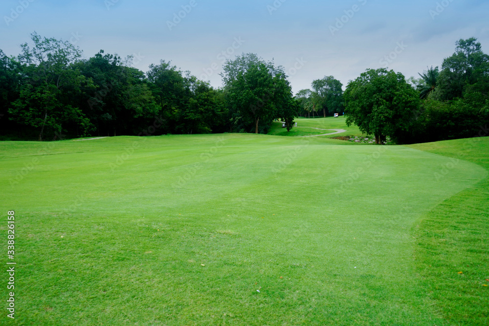 The evening golf course has sunlight shining down at golf course in Thailand The evening golf course has sunlight shining down at golf course in Thailand