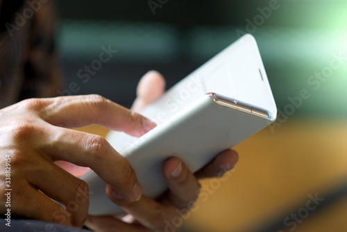 Focus hand of Young asian man touching smartphone